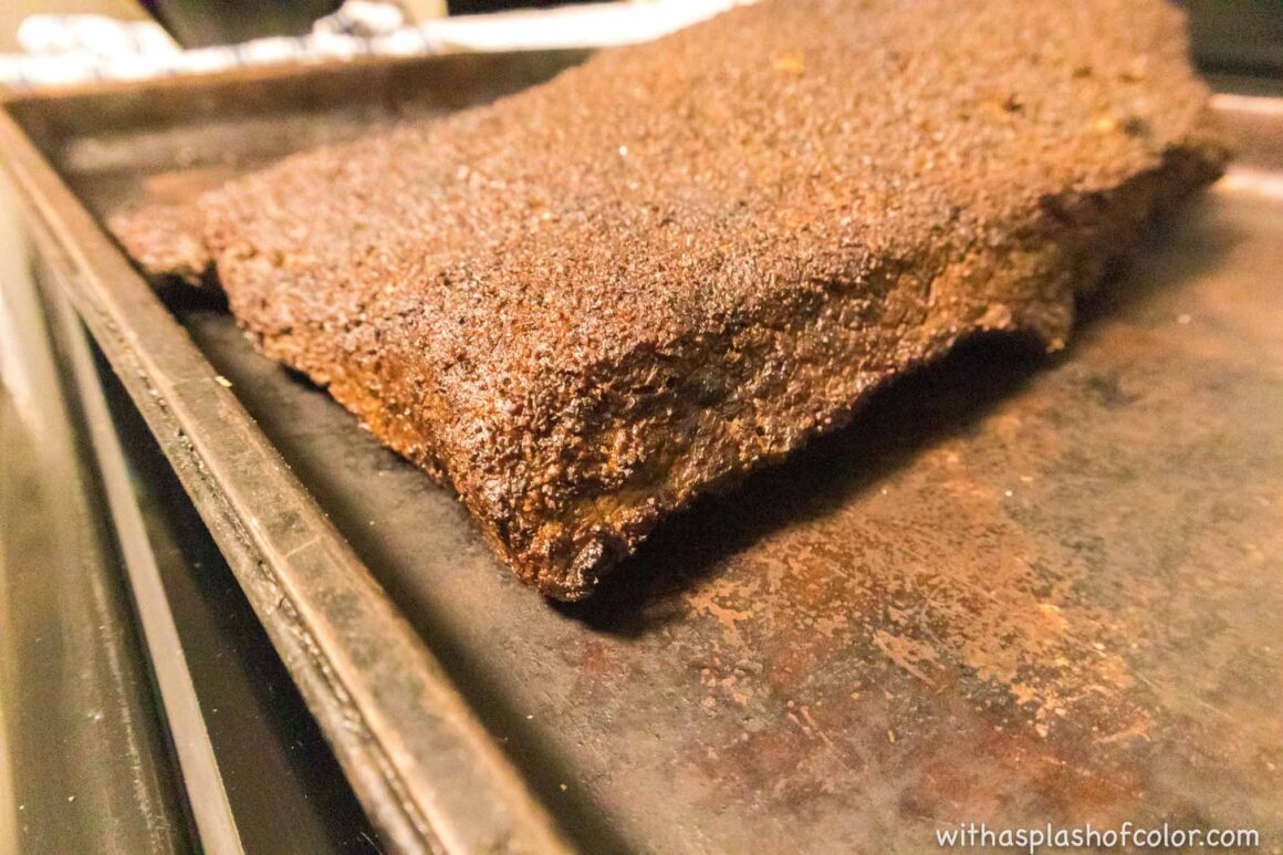 adding the brisket to the smoker 