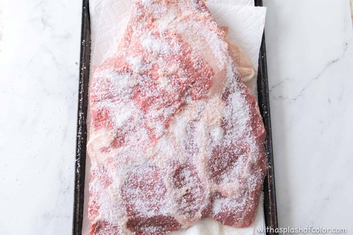 adding salt to the brisket 