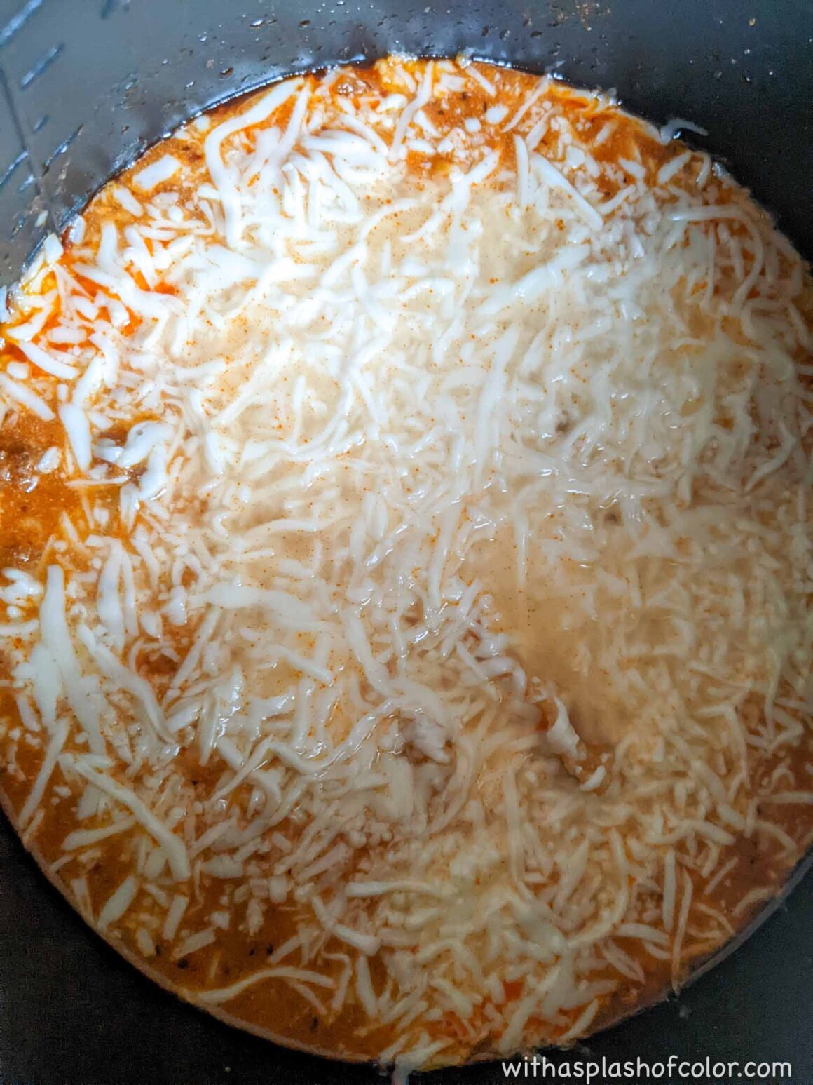 mixing in shredded cheese