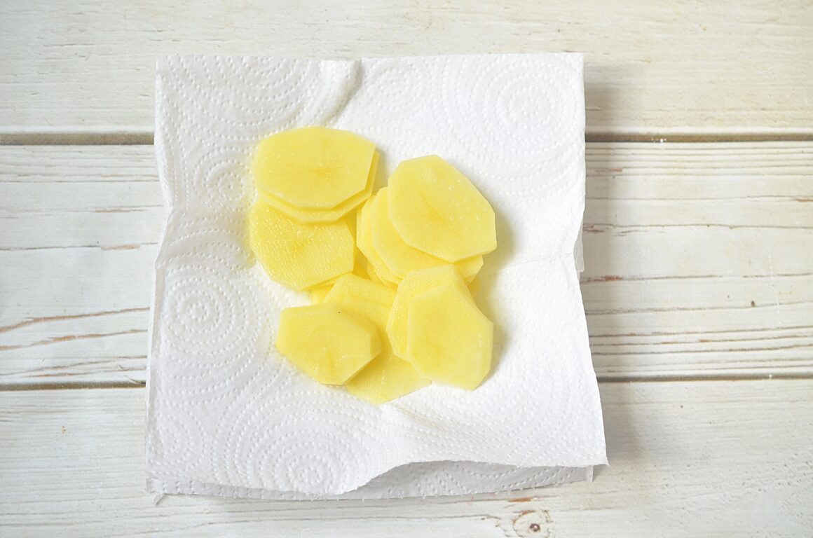 cutting potato slices on a towl