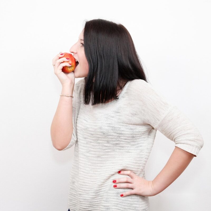 woman eating an apple.