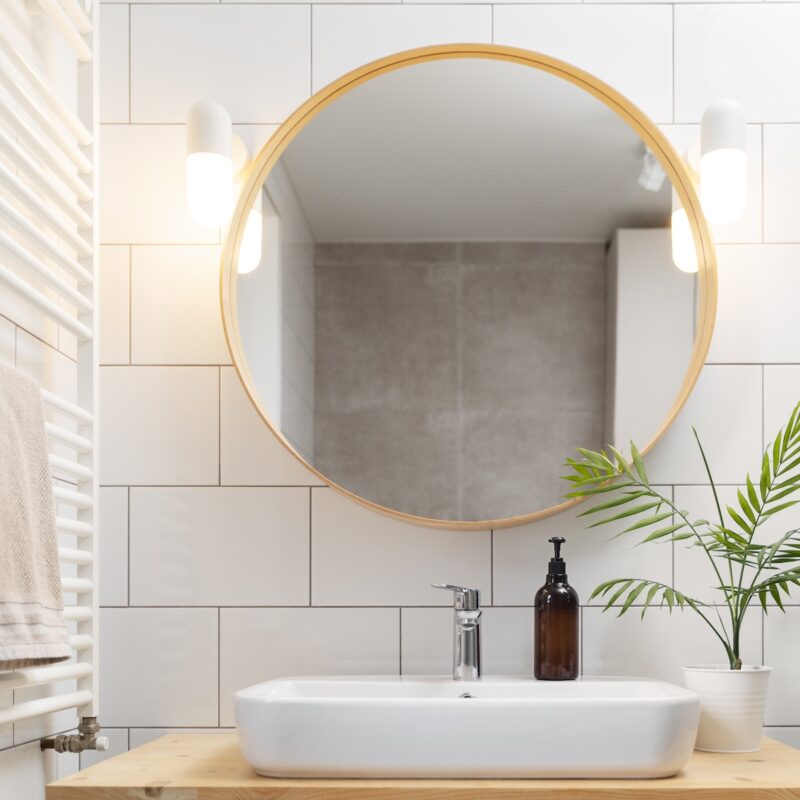 bathroom products near bathroom mirror.